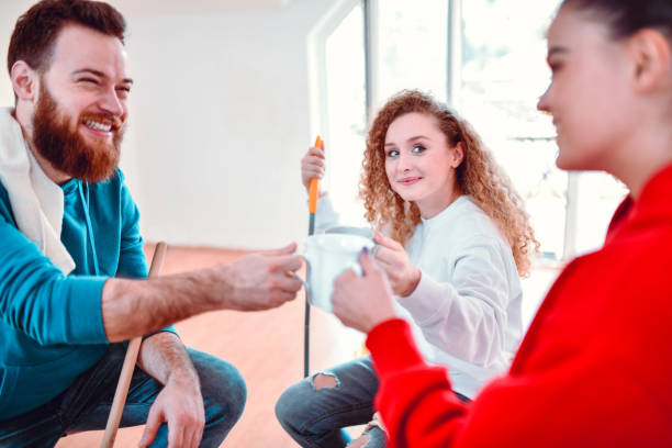 istock Coffee Celebratory Toast By Friends While Cleaning Their Apartment 1255991756