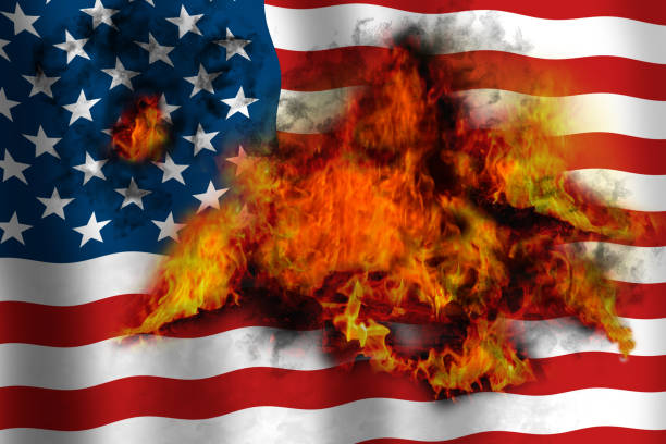istock American waving flag in flames burning from inside. 1255991885