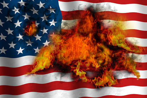 American waving flag in flames burning from inside. Concept image.