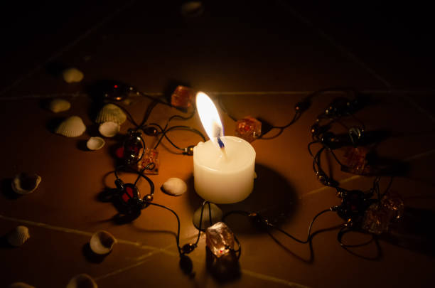 istock pentagram is painted on the floor, candles are lit, beads are lying, shells are scattered. concept of magic with occult and esoteric symbols. 1255992613