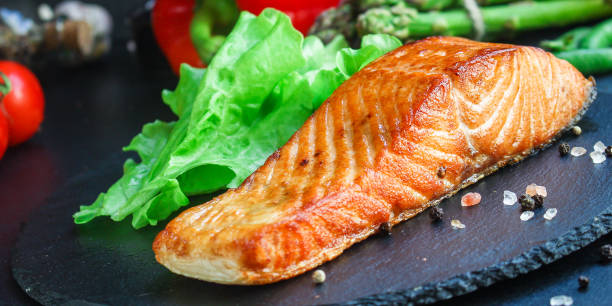 istock salmon barbecue grill fried Menu concept serving size. food background top view copy space for text keto or paleo pescatarian diet 1255992860