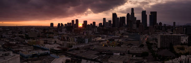 istock Sun Setting Between DTLA Buildings - Aerial Panorama 1255993814