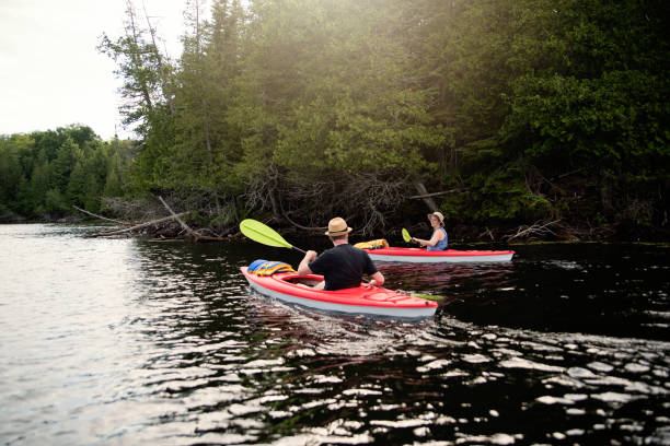 istock 50 + man and woman kayaking on a lake. 1255994046