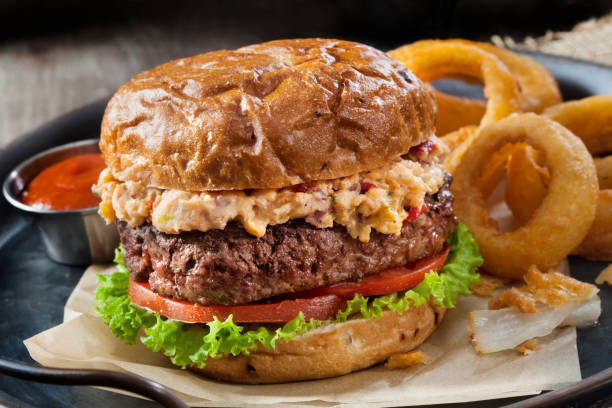 istock Pimento Cheese Burger with Lettuce, Tomato and Thick Cut Onion Rings 1255995546