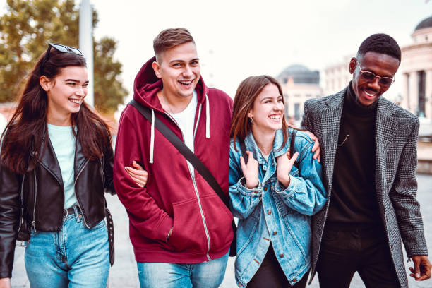 istock Smiling Couples Enjoying Walking In City Center Together 1255997306