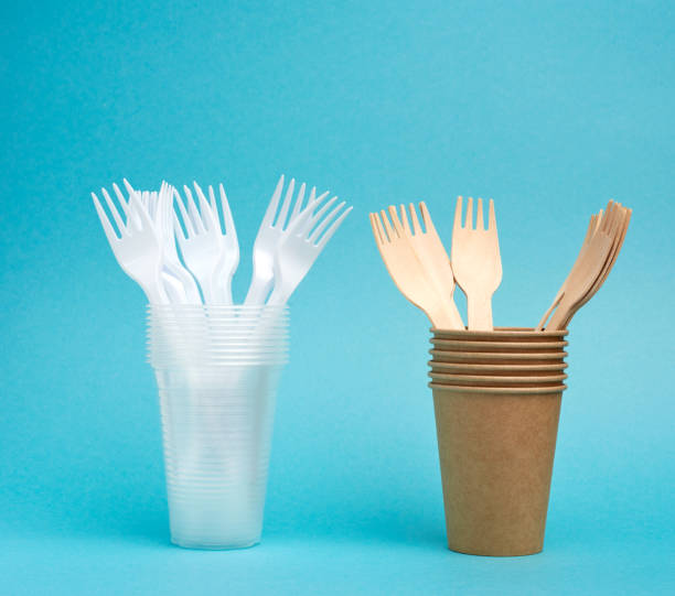 istock non-degradable plastic cups and fork from disposable tableware and a set of dishes from environmental recycled materials 1255999280