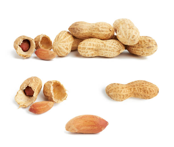 istock heap of peanuts in shell and broken 1255999324