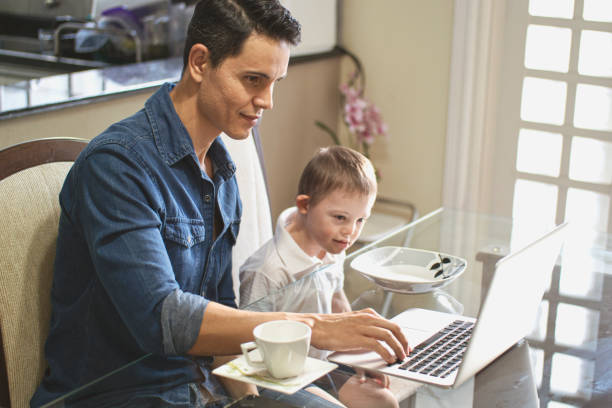 istock Man working at home with his son. 1256000244