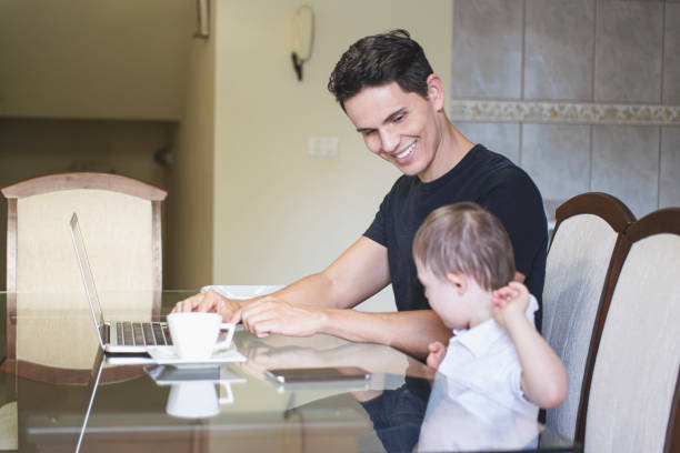istock Man working at home with his son. 1256000258