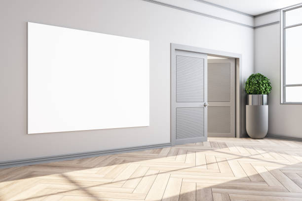 istock Clean home interior with door and empty billboard on wall 1256002264