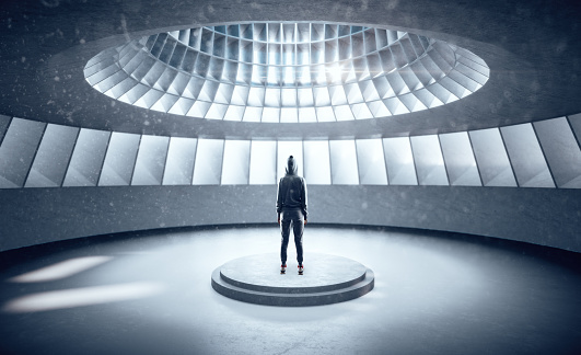 Hacker standing in futuristic hall interior with abstract wall and pedestal. Performance and presentation concept. 3D Rendering