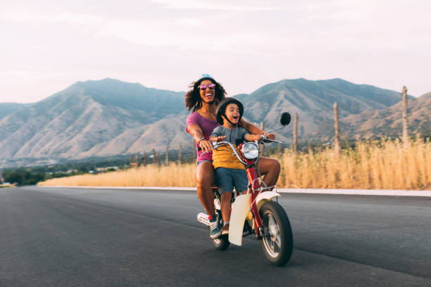Mother and Son Riding on Retro Scooter