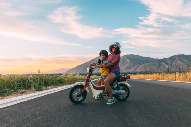 istock Mother and Son on Moped at Sunset 1256003134