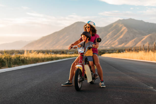 istock Mother and Son Riding on Retro Scooter 1256003151