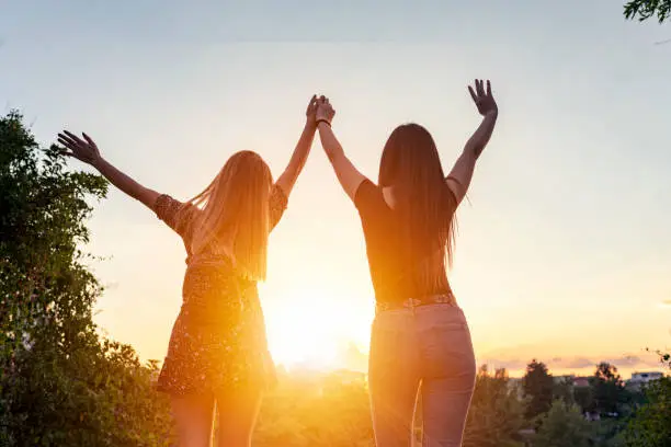 Photo of Two girls on sunset background. Best friends.