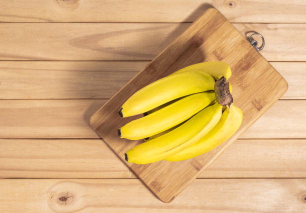 istock Bunch of bananas  on wooden table. 1256007996