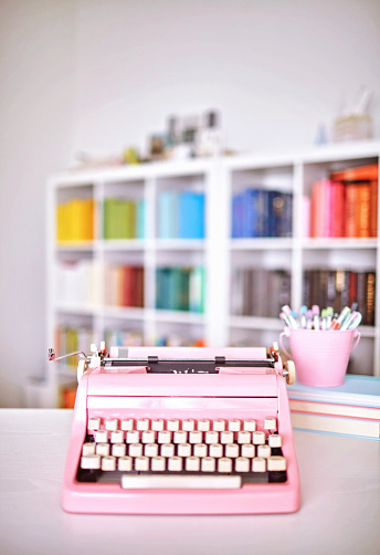 Modern home office with pink vintage typewriter