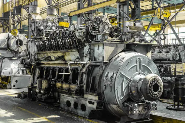 Photo of Diesel locomotive engine in a repair depot room