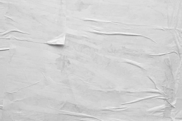 istock Blank white crumpled and creased paper poster texture background 1256012553
