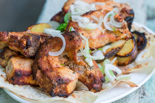istock Appetizing pork grill skewers with onions on a plate 1256012727