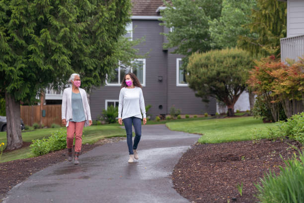 istock Two women wearing protective face masks enjoying the outdoors during Coronavirus 1256012771