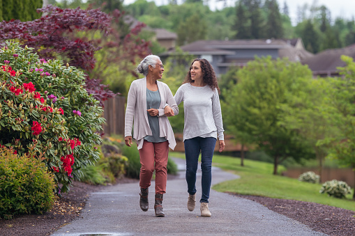 Senior woman and her adult daughter enjoying the outdoors together during Coronavirus