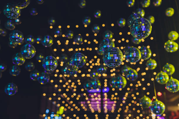 istock lots mirror disco ball hanging on with colorful lighting reflection. 1256013099