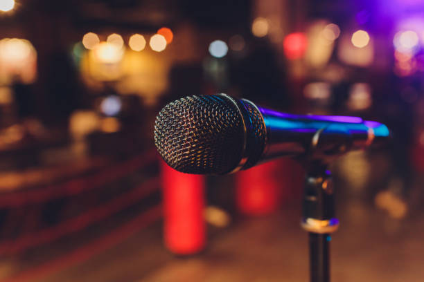 istock Close up of microphone in concert hall or conference room. 1256013169