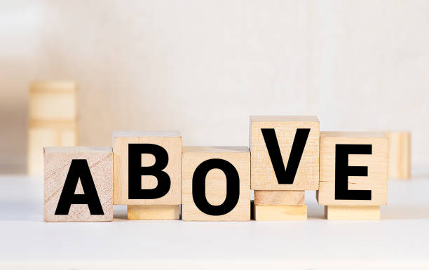 istock Wooden blocks with word HYPNOSIS on dark background, above view 1256013346