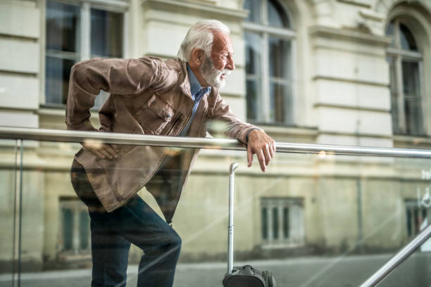 istock Traveling senior man with back pain. 1256015881