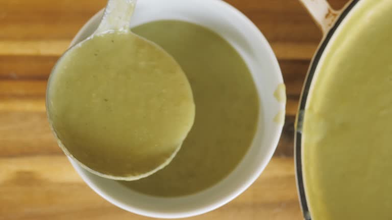 filling the leek potato soup into a bowl