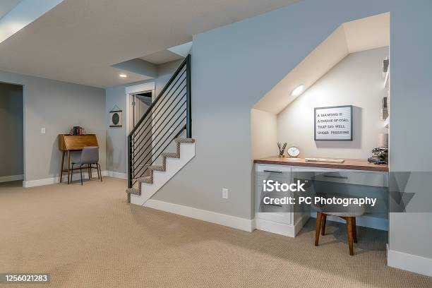 Basement Rec Room With Home Office Desk Underneath The Stairs Stock Photo - Download Image Now