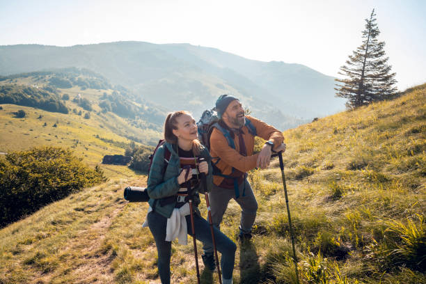 istock Young couple hiking in the mountains 1256021405