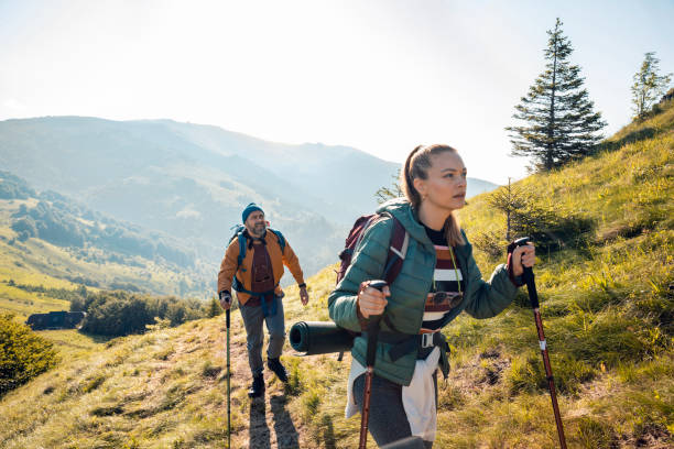 istock Young couple hiking in the mountains 1256022220