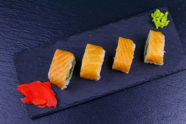 istock Sushi rolls Philadelphia on a black slate. Top view 1256022844