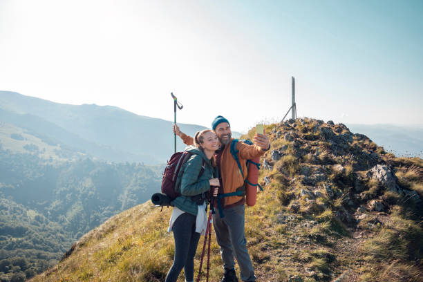 istock Young couple taking a selfie while out hiking 1256022911