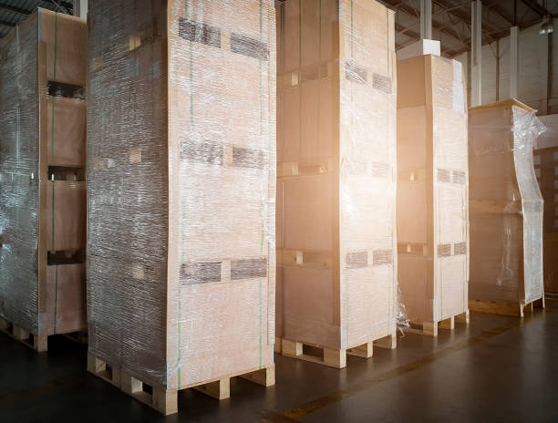 istock Stack of wooden crates at interior warehouse storage. Large shipment goods, Cargo & Shipping warehouse, Logistics and transportation. 1256024760