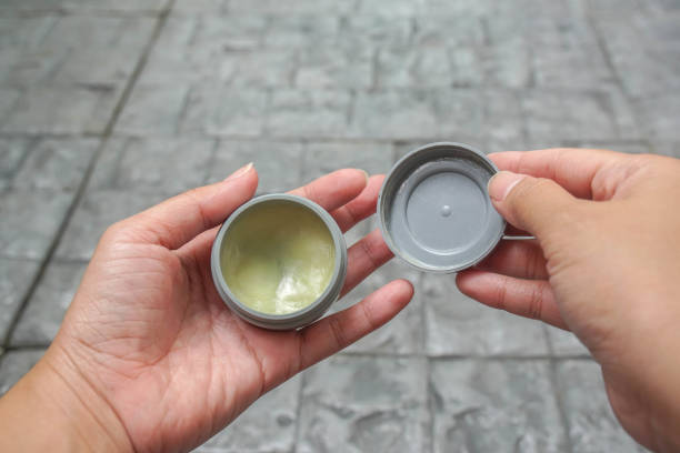 istock isolated people hands hold setting wax product in for hair styling before going to work 1256027834