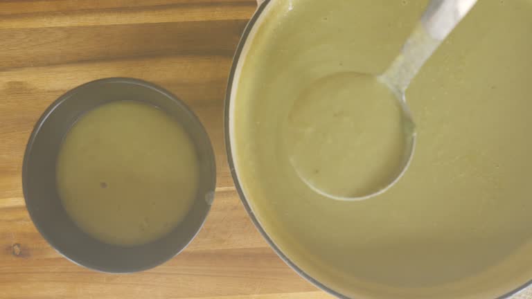 filling the leek potato soup into a bowl