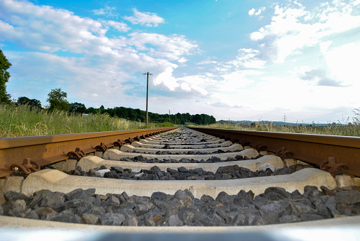 Different views of railroad tracks taken at the Wellesley Farms Commuter rail station in Wellesley, MA just outside of Boston, MA.  In addition to the rails, the photos show the bold yellow caution line and the \