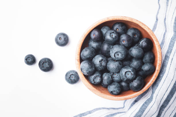 istock Blueberries in wooden bowl 1256032972