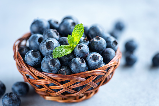 Fresh organic blueberries in basket. Closeup view juicy blueberries