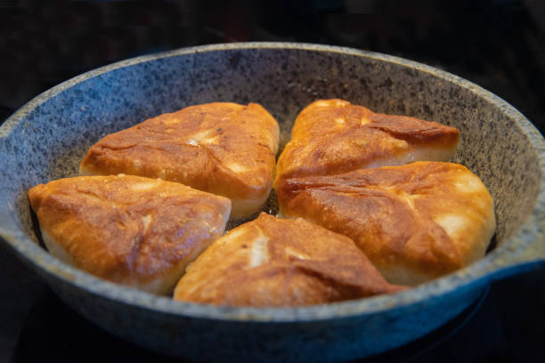 istock gray plate with delicious fried pies on a black background, isolate 1256041882