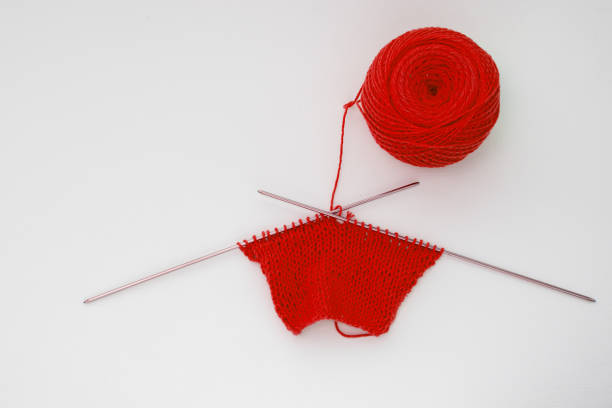 istock Top view of a knitted pattern of red yarn on an isolated background, copy space. Needlework concept, handmade 1256041947