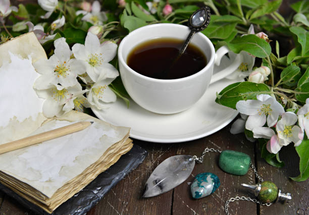 istock Cup of tea with open diary and apple tree flowers on planks. 1256042655