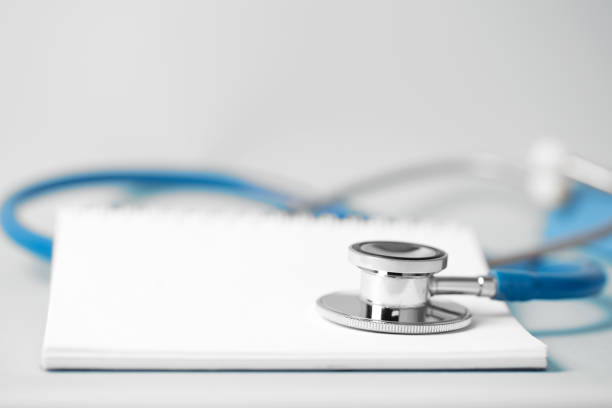 istock Medical concept - stethoscope with a spiral notebook 1256042799