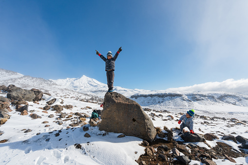 Kids enjoying weekend activities in snow heading towards Mt Ruapehu, National Park, New Zealand.