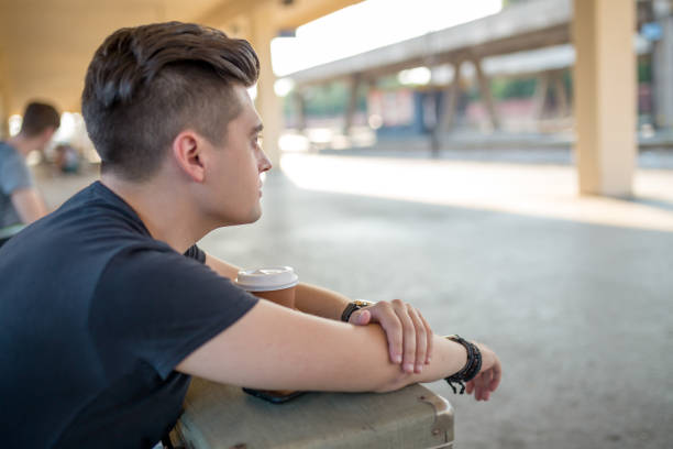 istock Man standing on the subway platform, waiting for his train. 1256047281