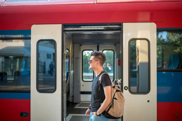 istock Man standing on the subway platform, waiting for his train. 1256047316