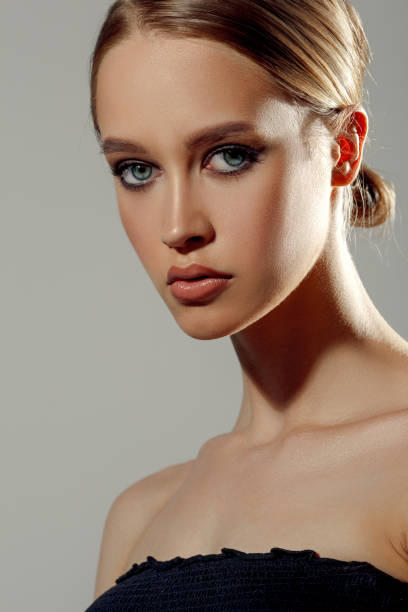 istock Beautiful woman face closeup studio portrait 1256049024